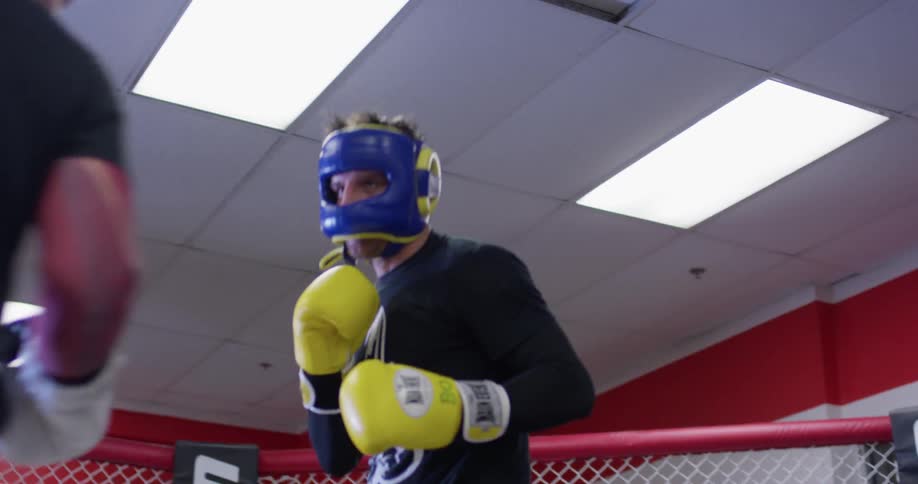 Two men box in a boxing ring