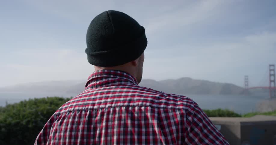 A man looks out over the water from the skate park