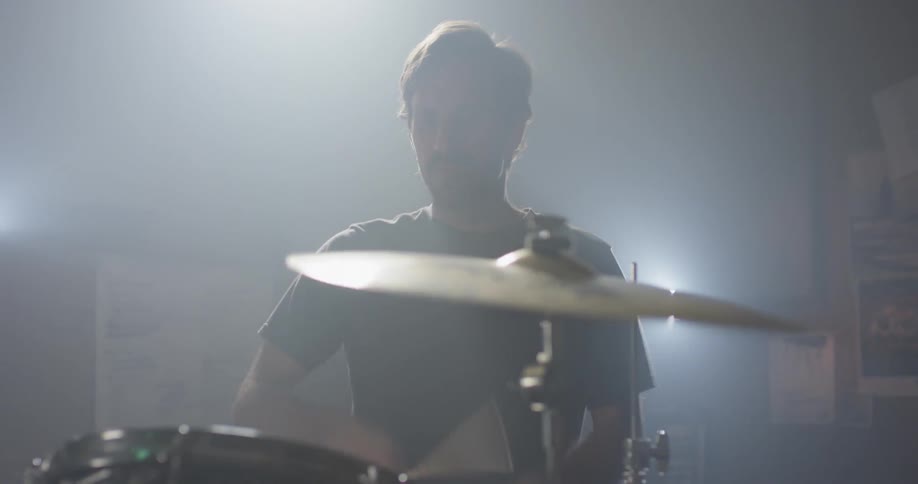 A drummer plays on the drum kit