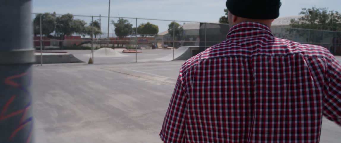 A man enters a skate park