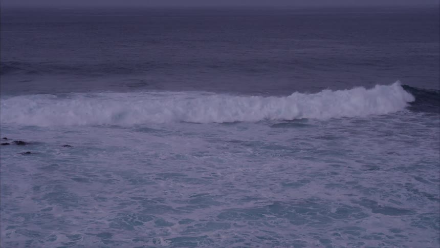 The rough tide flows towards the shore