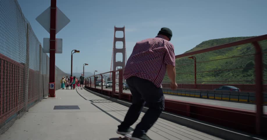 A man skateboards by the busy road