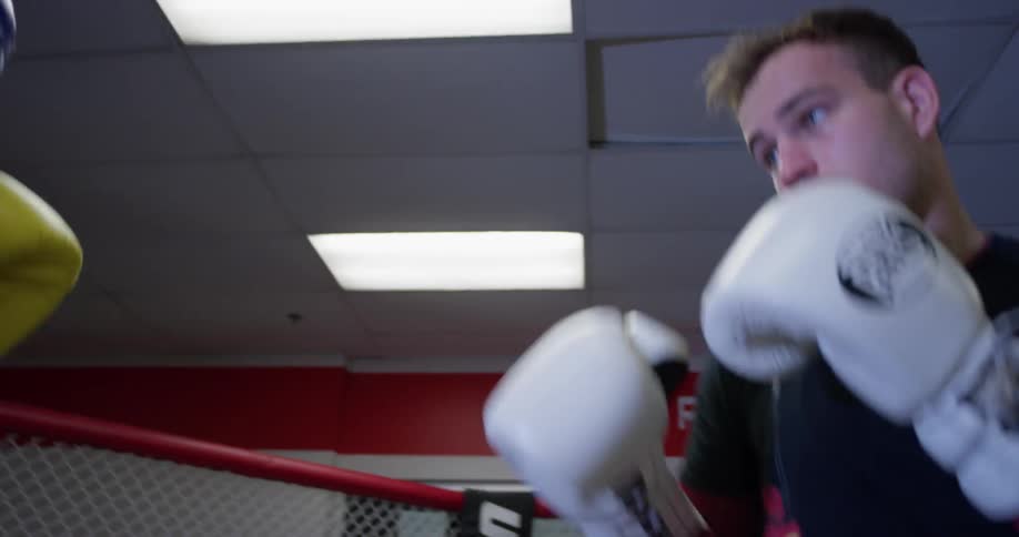 Two boxers spar in a fighting ring