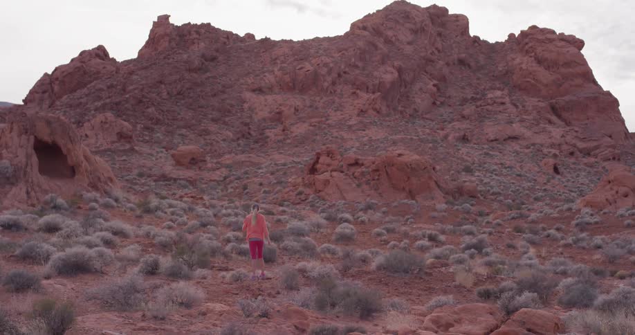 A woman jogs in a desert
