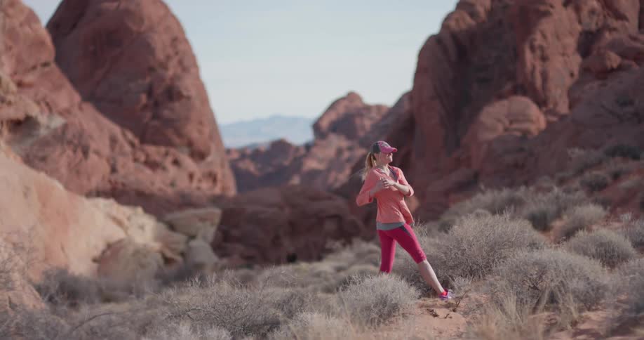 A woman stretches in a desert