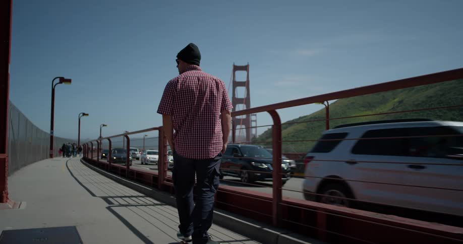 A man skateboards by the busy road