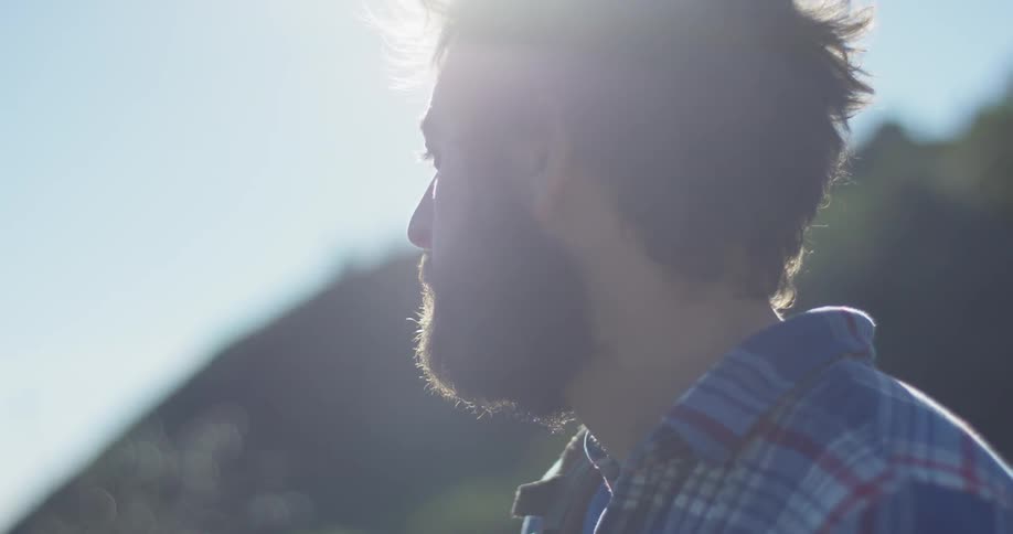 Man stands in nature on a sunny day