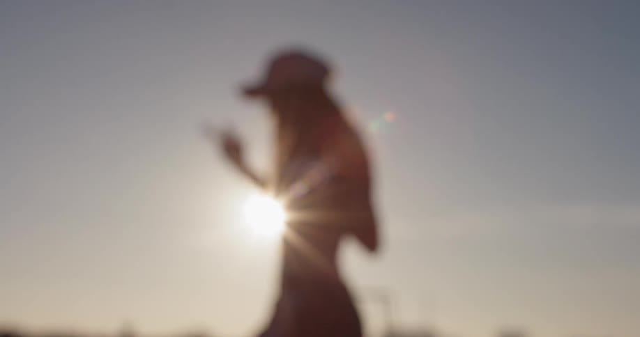 A woman dances on a building rooftop