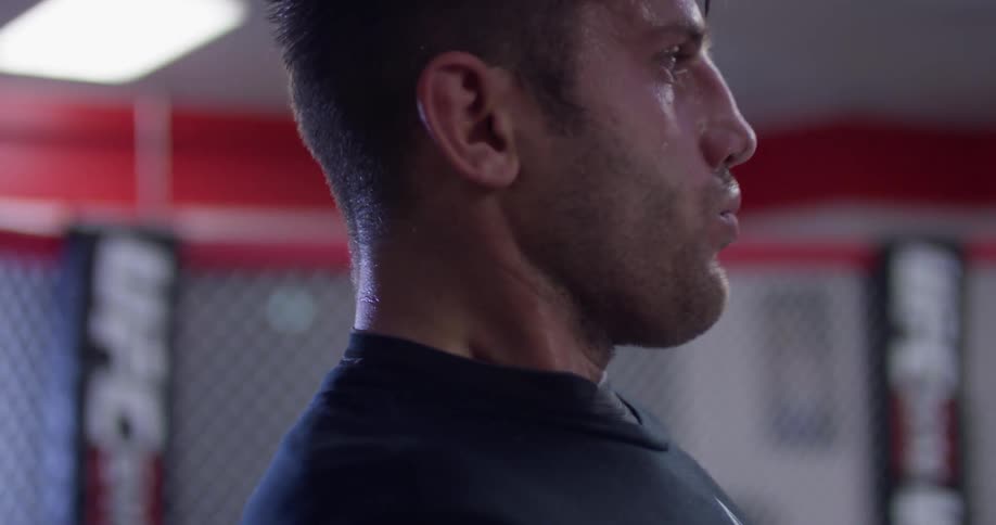 A man exhales to catch his breath in a mma ring