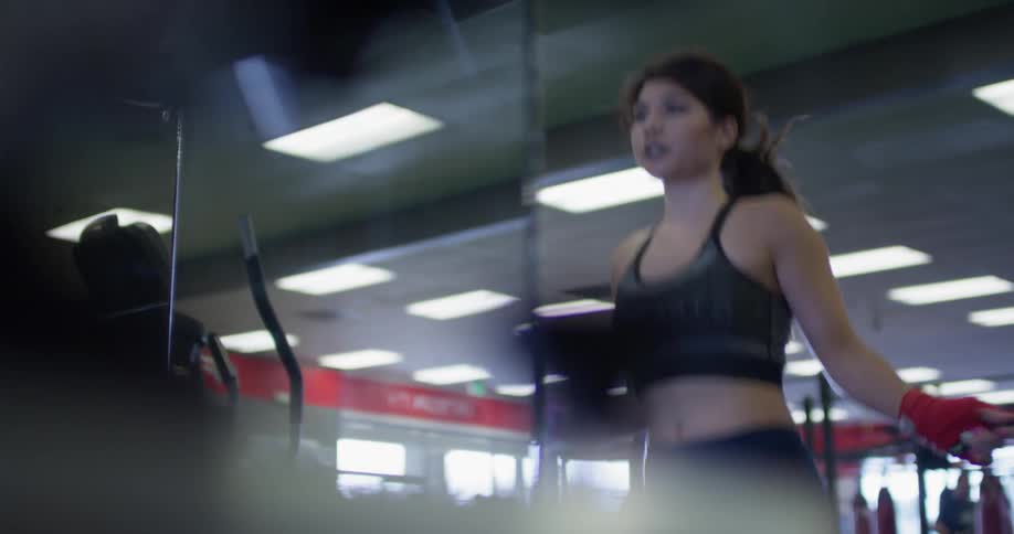 A woman jumps rope in a gym