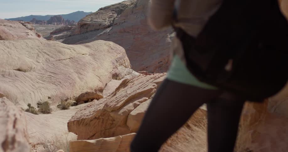 A person stands on top of the canyon