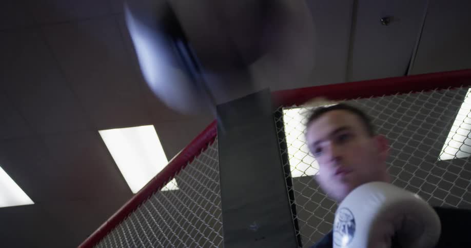 A man is punching a speed bag