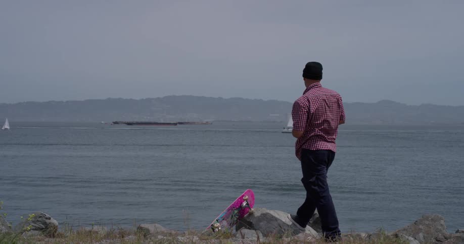 Man throws an object into a large body of water