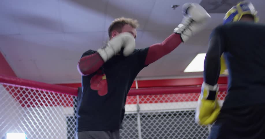 Two men practice boxing in a boxing ring