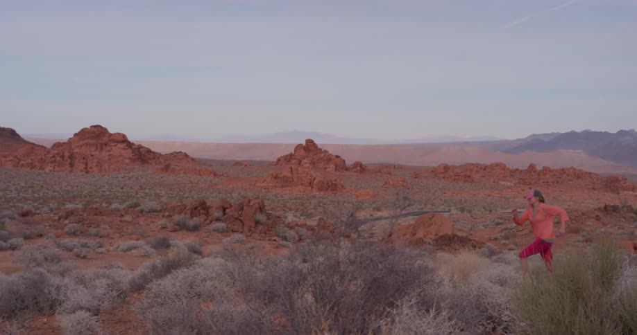 A woman jogs in a desert