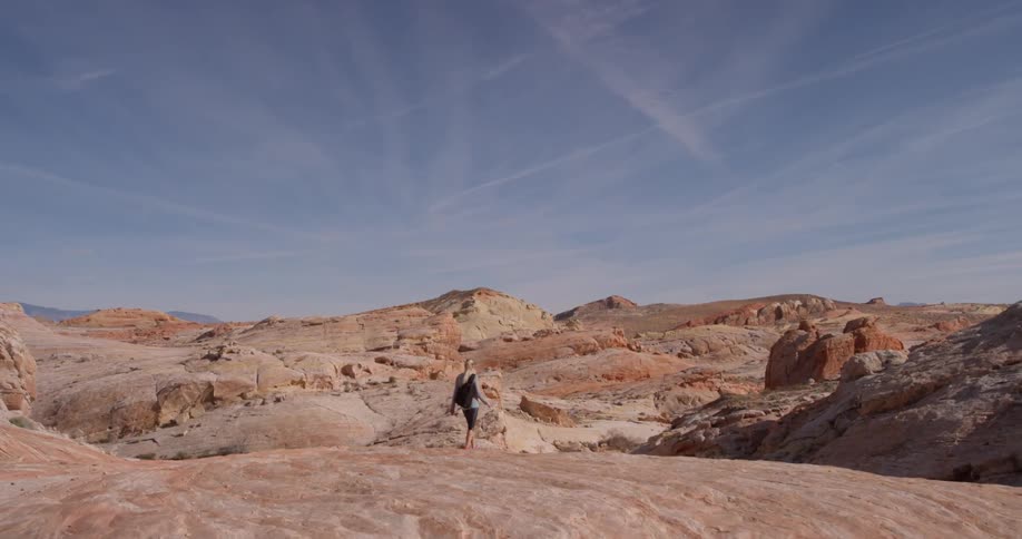 A woman hikes alone in a desert