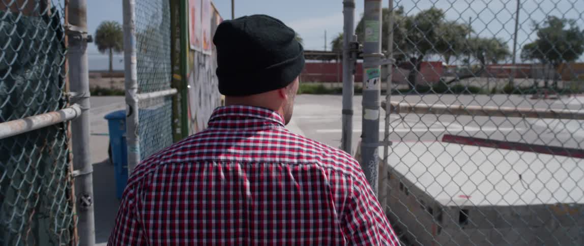 A man enters a skatepark