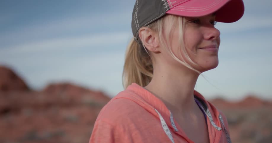 A woman hikes alone in a desert