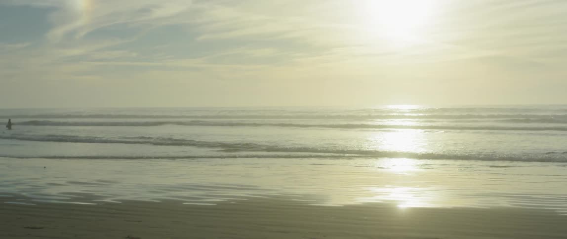 The sun shines on a sandy beach