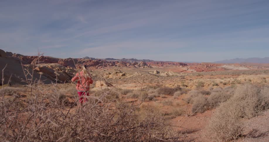 A woman jogs in a desert
