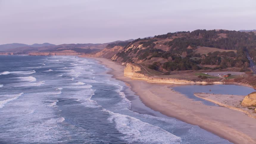 The tide flows onto the beach shore