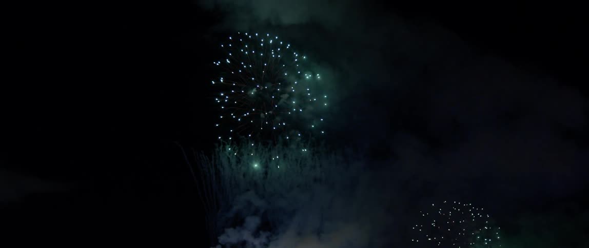 The fireworks explode high in the sky