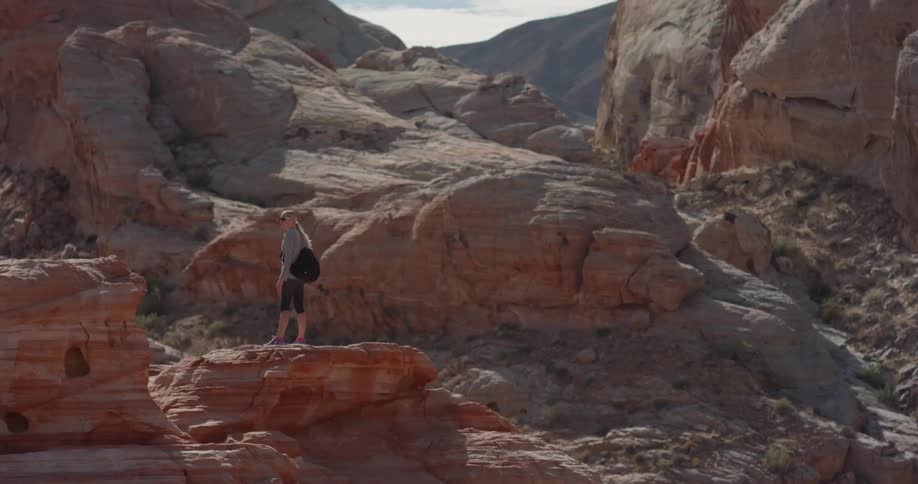 A woman hikes alone in a desert
