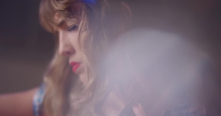 Woman plays cello in a brightly lit room
