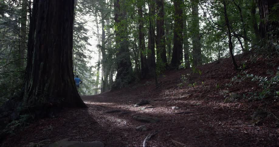 A man jogs fast up the hill
