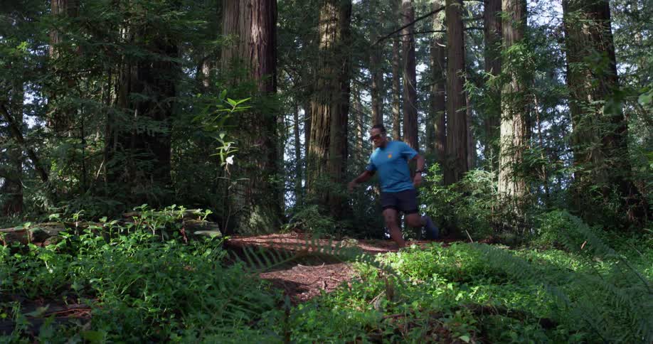 A man runs in a forest