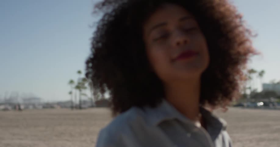 A woman poses on the beach