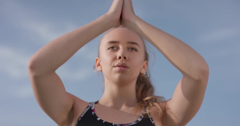 A woman does yoga outside