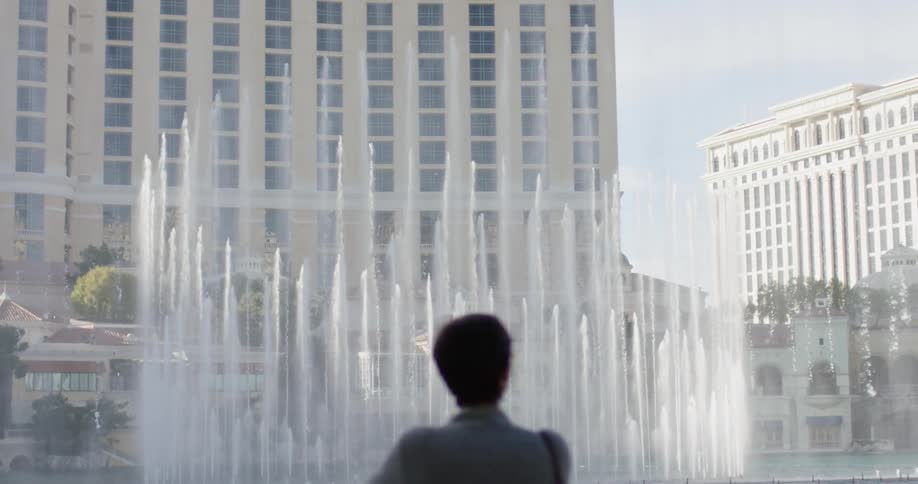 A woman watches fountains in las vegas