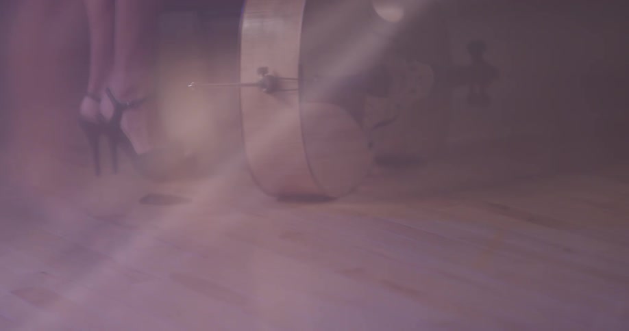 A woman walks over towards the double bass