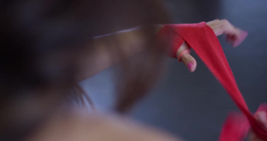 Woman tapes up her hand for boxing