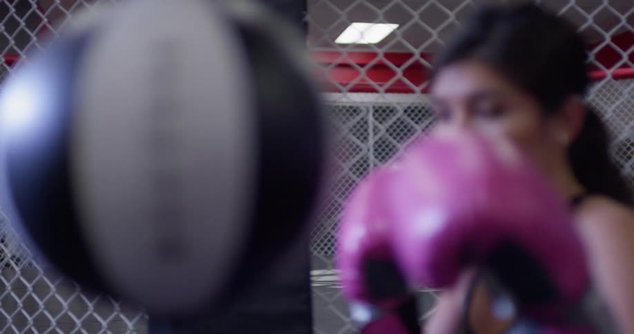 A female boxer hits a punching bag