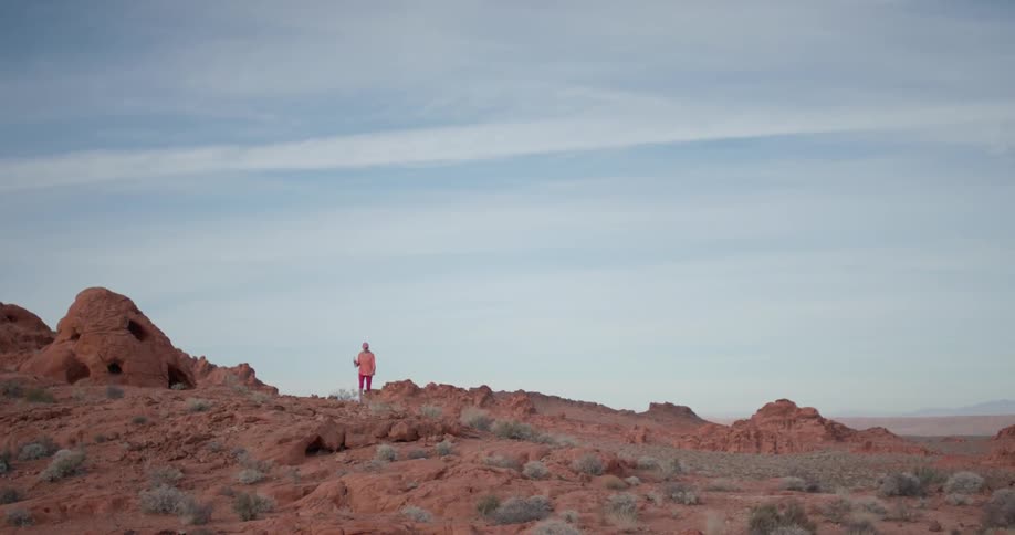 A person walks on the rocks ahead