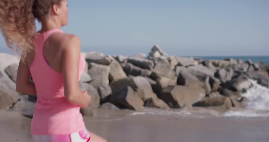 Woman jogs in place on the beach