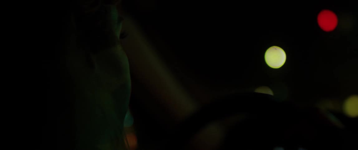 A person is sitting in the car at night