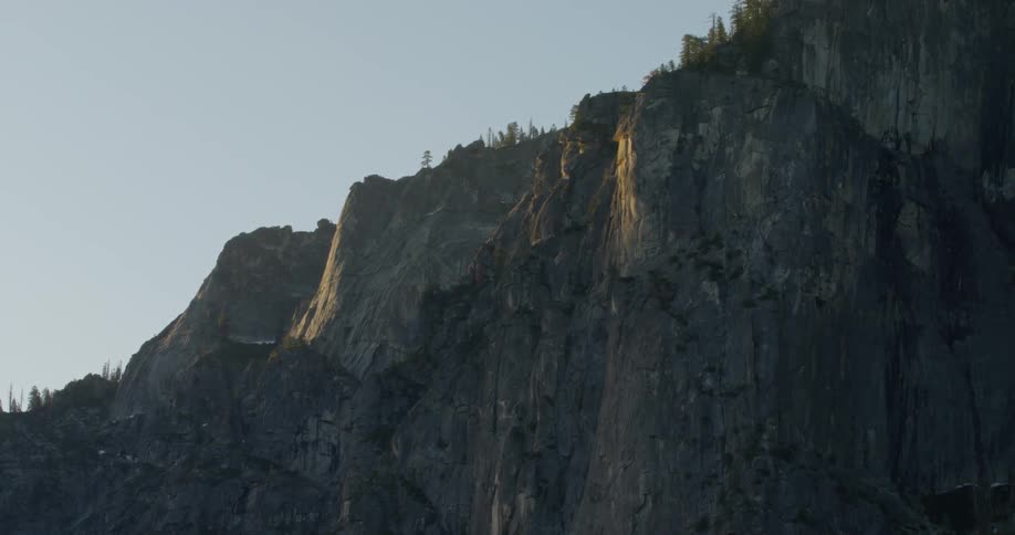 The tall mountain has green at the top