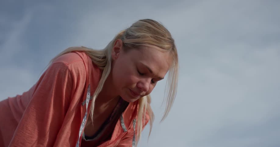 A woman leans forward tired