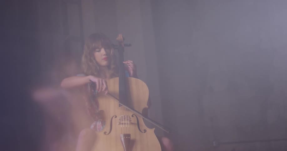 A woman picks the stick up to play the double bass