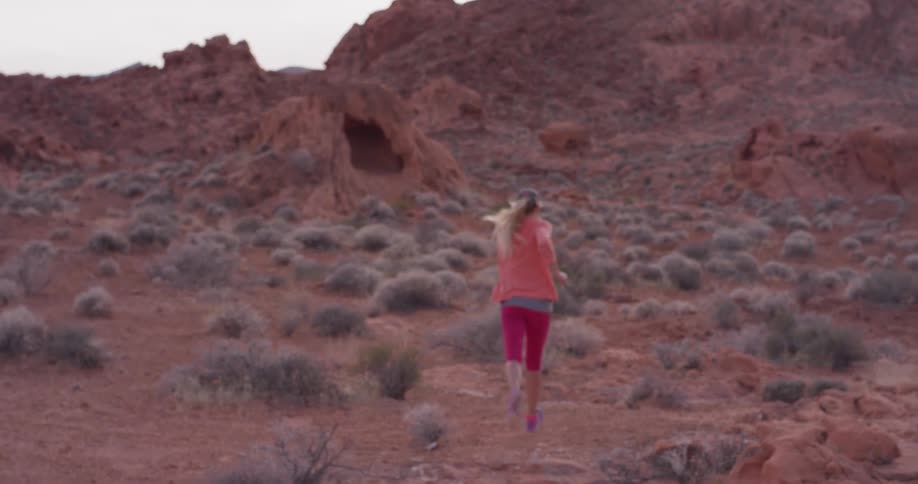 A woman jogs in a desert