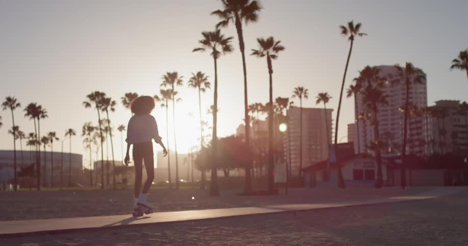 Woman Rollerblading Around Beach