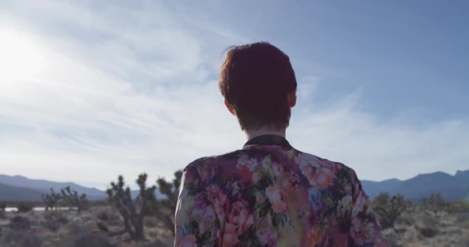 A woman enjoys the view as she walks in the desert