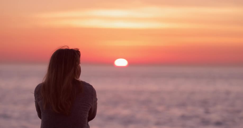 Woman Watching Sunset At Beach