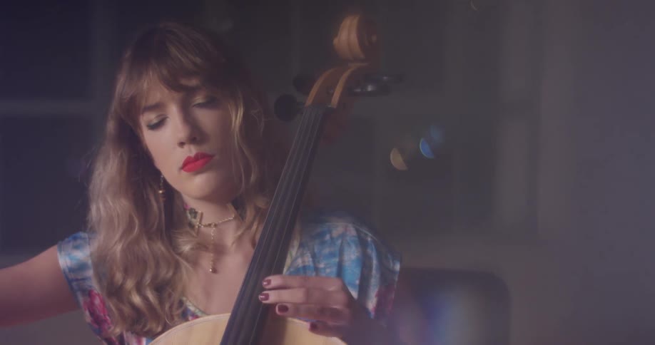 A woman closes her eyes as she plays the double bass