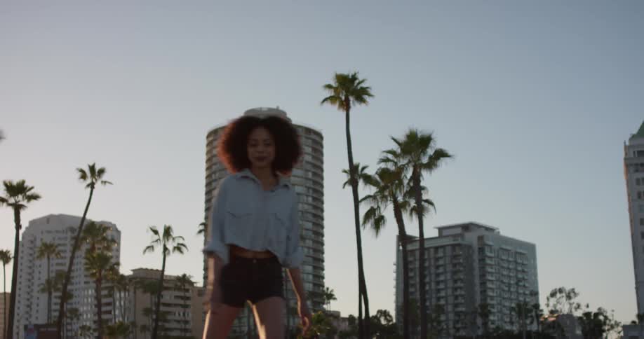 A woman is rollerskating and smiling