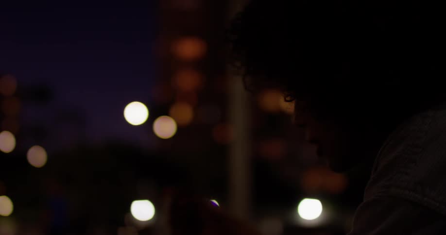 A woman is sitting at night