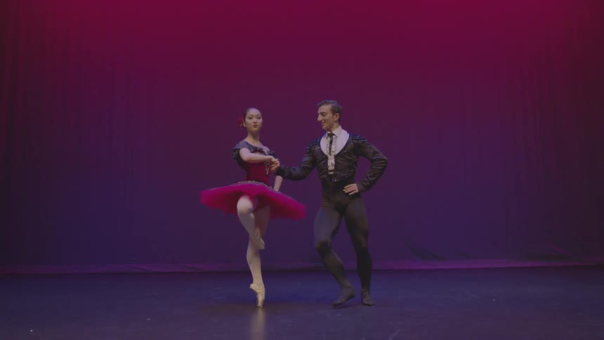 A male and female ballet dancer perform on stage